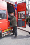 Sam loading customer's shopping into our red bus