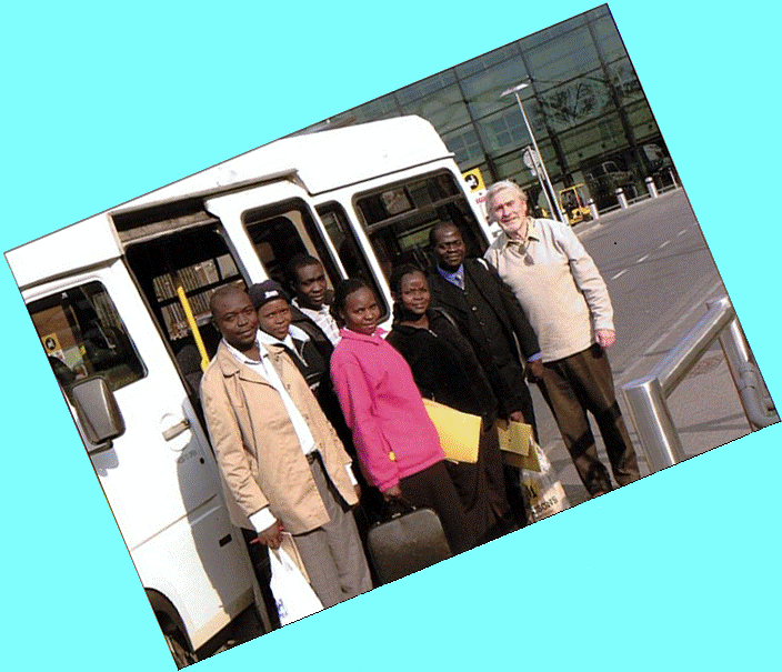 Rotary Club of Wem & District President Iain McHardy (far right), alongside a North Salop Wheelers 16 seat minibus, with 6 teachers from the Miriu schools in Kenya arriving at Heathrow Airport on their way home following an exchange visit to Thomas Adams School, Wem and Buntingsdale School, Tern Hill during May 2010
