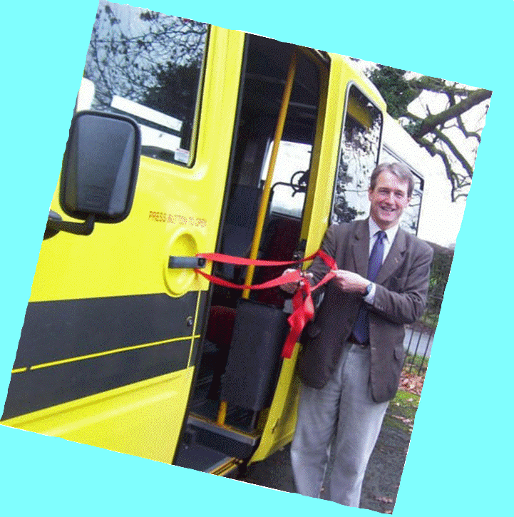 Our MP Owen Paterson cuts the tape  on first yellow bus acquired with the funding help of Whixall Parish Council